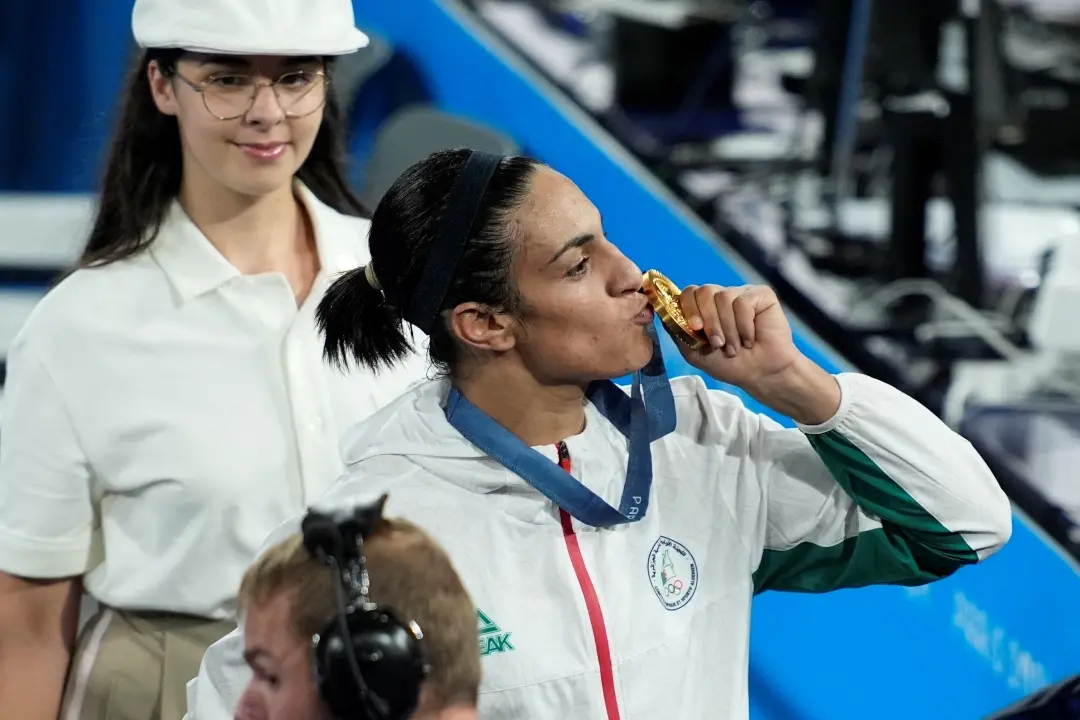 Gold medalist Algeria's Imane Khelif kisses the medal for the women's 66 kg final boxing match at Paris Olympics