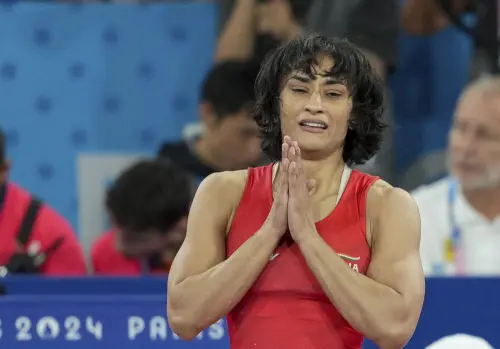 India's Vinesh Phogat celebrates after winning her Women's Freestyle 50kg semi-final wrestling match against Cuba's Yusneylys Guzman Lopez at the 2024 Summer Olympics in Paris. | Photo: PTI