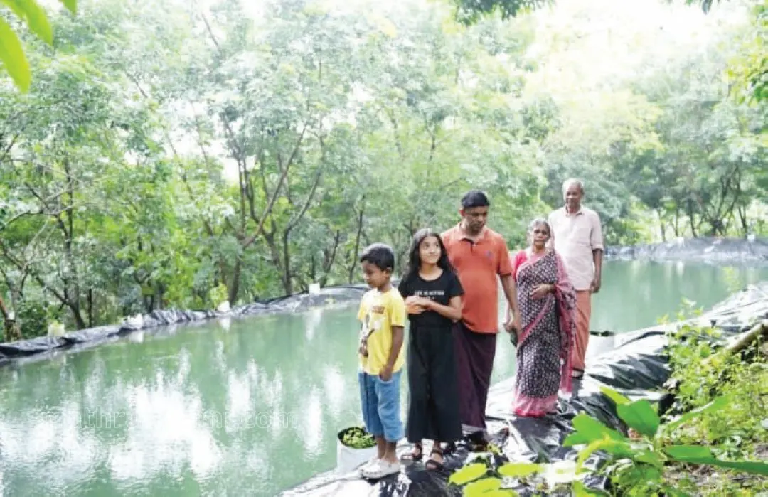 Rajesh Scaria and his family near the rainwater tank
