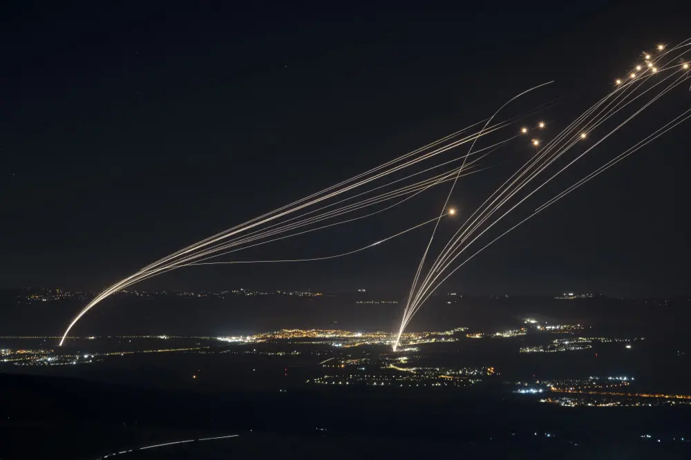 The Israeli Iron Dome air defense system fires to intercept an attack from Lebanon over the Galilee region as seen from the Israeli-annexed Golan Heights | AFP
