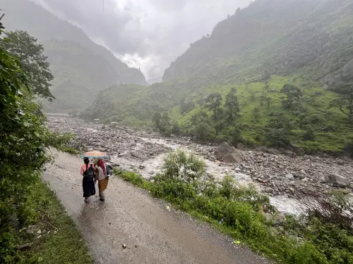 Women walk on a road amid rains at cloud-burst hit Samej village, in Rampur area of Shimla district. | Photo: PTI