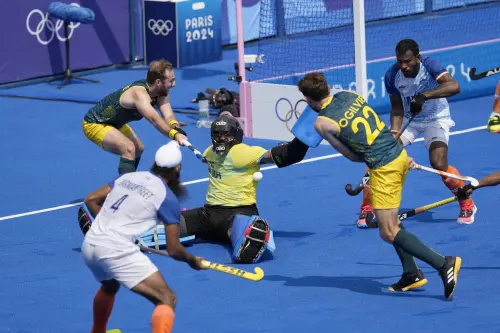 India's goalkeeper Parattu Reveendran Sreejesh, center, makes save a goal attempt by Australia's Flynn Ogilvie, second right, during the men's field hockey match between Australia and India at the Yves-du-Manoir Stadium, at the 2024 Summer Olympics. | Photo: AP/PTI