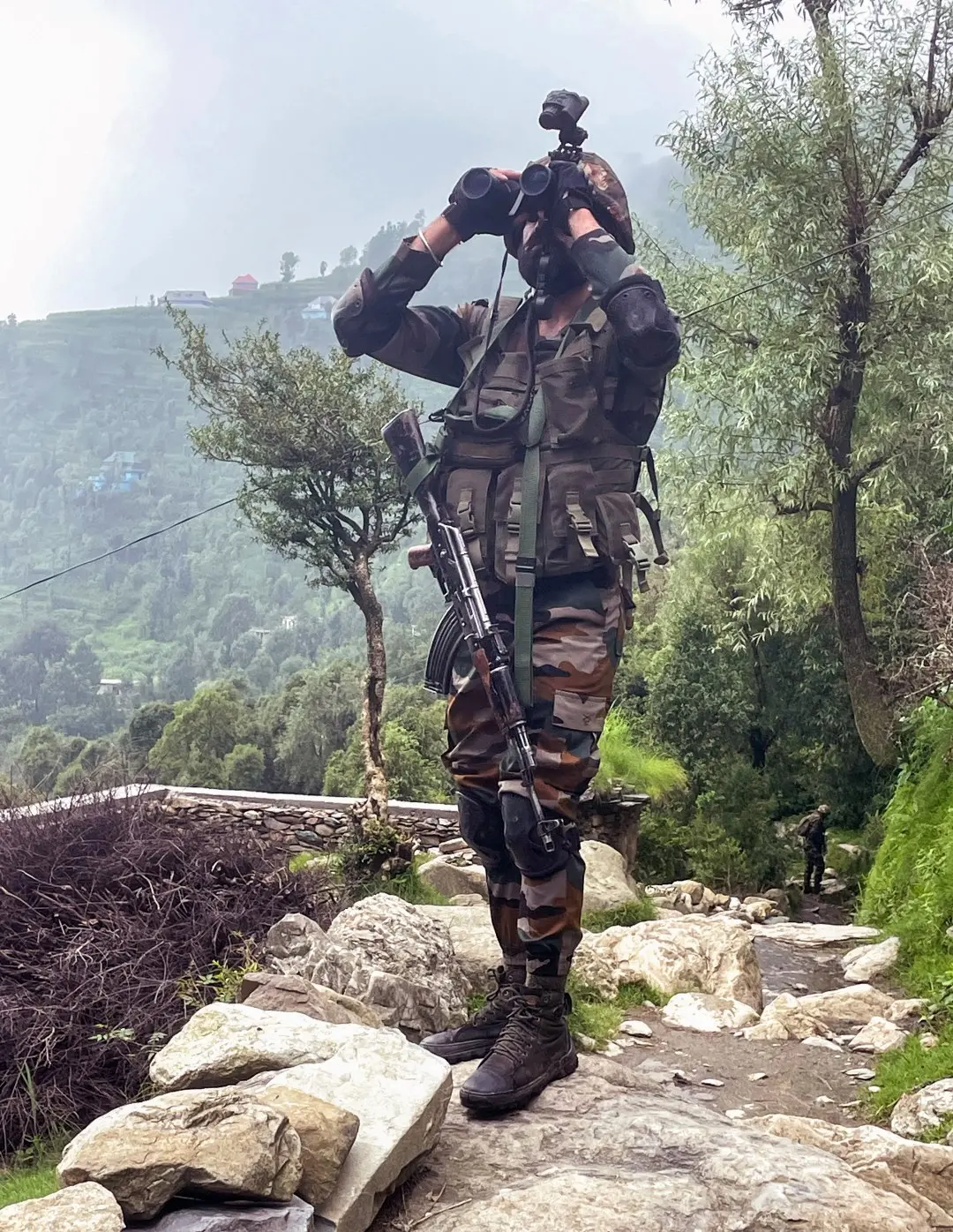 Army personnel using binoculars during a search operation in view of rising terror incidents across Jammu region