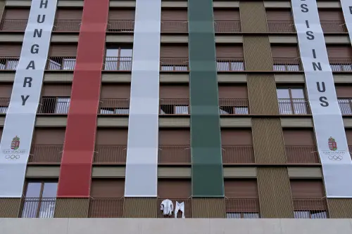 A marital arts uniform hangs outside a window of the Hungarian team's residence in the Olympic Village. | Photo: AP
