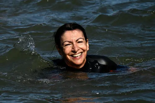 Paris Mayor Anne Hidalgo swims in the Seine, in Paris, to demonstrate that the river is clean enough to host the outdoor swimming events at the Paris Olympics later this month. | Photo: AFP