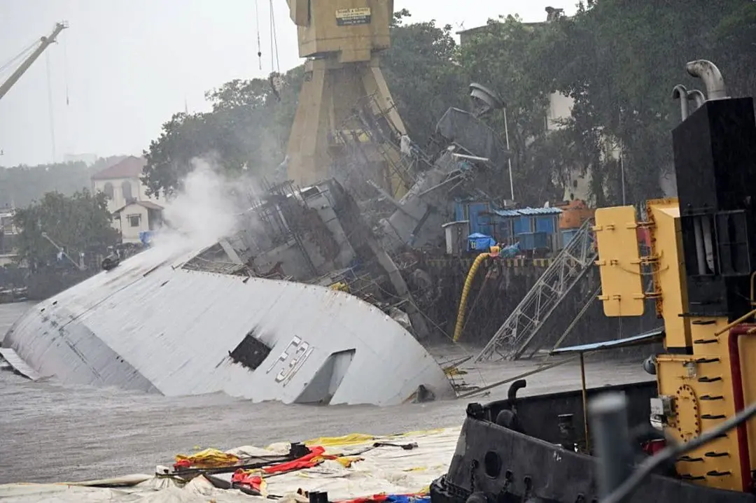 Navy frigate INS Brahmaputra tilts to one side (port side) inside naval dockyard, in Mumbai