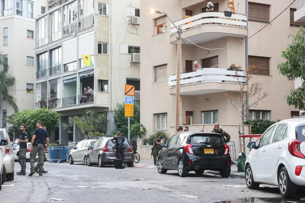 Israeli policemen search the scene where an explosion took place in Tel Aviv | AFP
