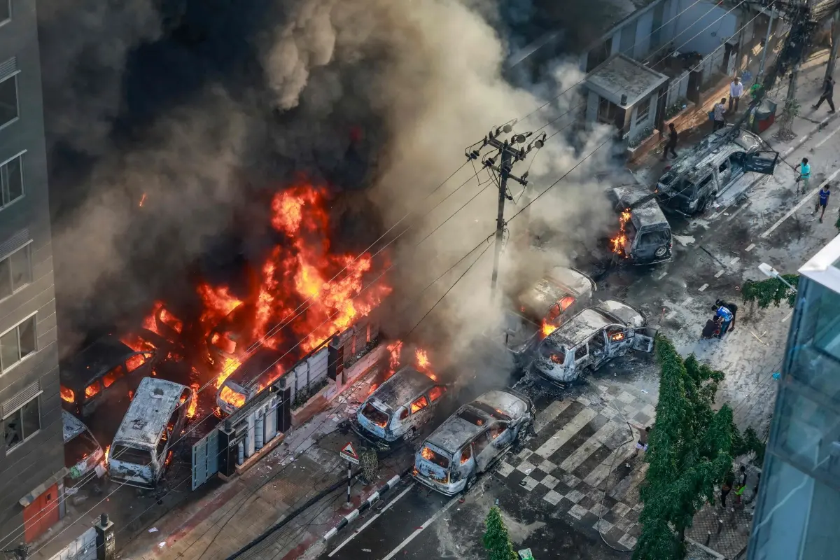 Smoke rises from the burning vehicles after protesters set them on fire near the Disaster Management Directorate office during the ongoing anti-quota protest in Dhaka | Photo: AFP