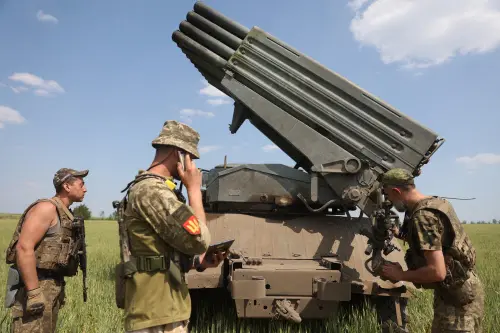 Ukrainian artillerymen prepare to fire a BM-21 Grad multiple rocket launcher | AFP