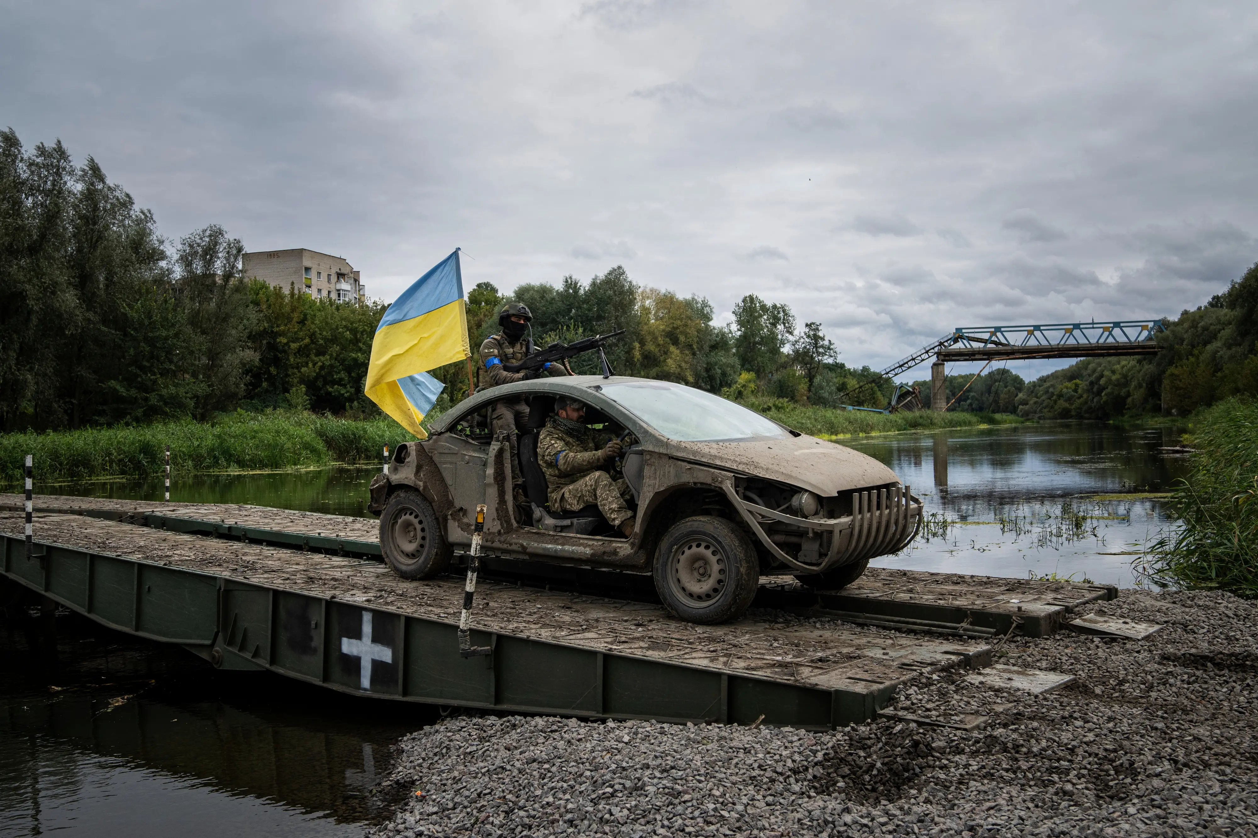 Ukrainian paratroopers drive with a Ukrainian flag on a pontoon bridge across Siverskiy-Donets river . Photo:AP