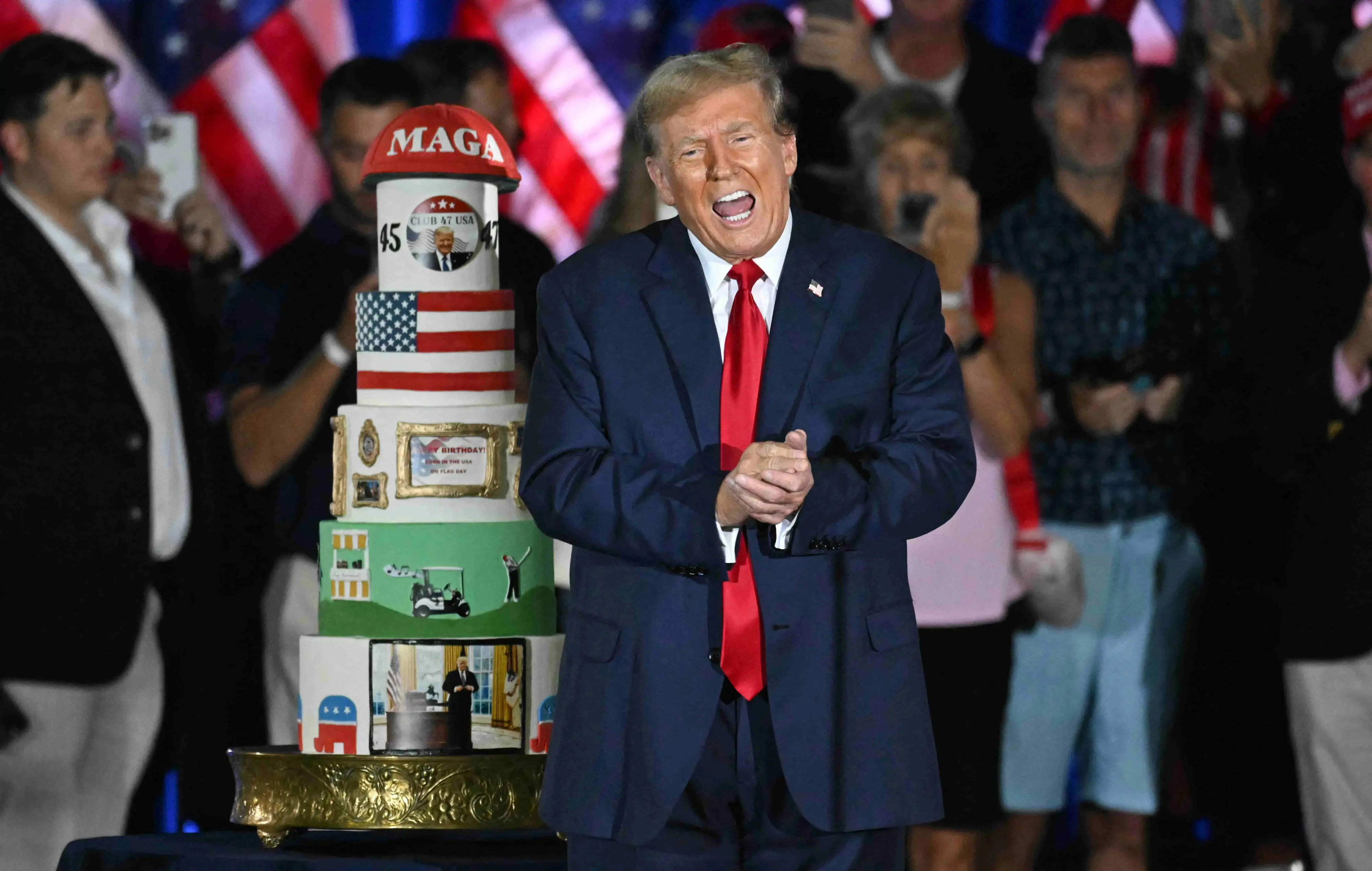 Donald Trump with his birthday cake | Photo: AFP