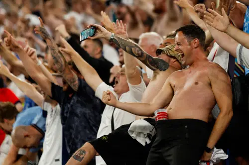 England's fans celebrate during the UEFA Euro 2024 semi-final football match between the Netherlands and England at the BVB Stadion in Dortmund | Photo: AFP