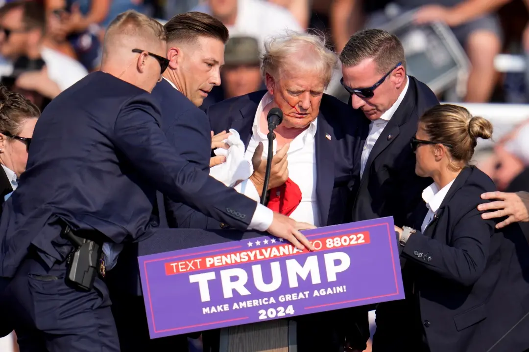 Republican presidential candidate former President Donald Trump is helped off the stage at a campaign event in Butler, Pa.