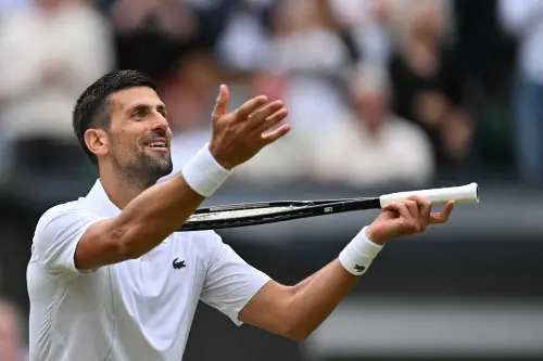Serbia's Novak Djokovic imitates playing the violin with his racquet as he celebrates winning against Italy's Lorenzo Musetti during their men's singles semi-final tennis match on the twelfth day of the 2024 Wimbledon Championships at The All England Lawn Tennis and Croquet Club in Wimbledon, southwest London. Djokovic won the match 6-4, 7-6, 6-4. | Photo: AFP