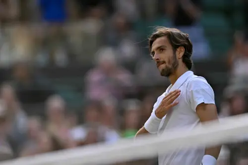 Italy's Lorenzo Musetti celebrates winning against US player Taylor Fritz during their men's singles quarter-finals tennis match on the tenth day of the 2024 Wimbledon Championships at The All England Lawn Tennis and Croquet Club in Wimbledon | Photo: AFP