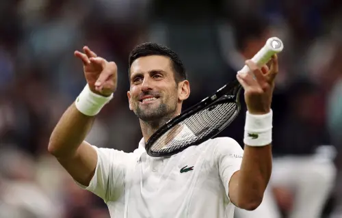 Novak Djokovic of Serbia pretends to play a violin after defeating Holger Rune of Denmark in their fourth round match at the Wimbledon tennis championships in London | Photo: AP