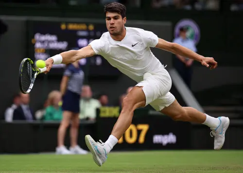 Spain's Carlos Alcaraz returns against France's Ugo Humbert during their men's singles fourth round tennis match on the seventh day of the 2024 Wimbledon Championships at The All England Lawn Tennis and Croquet Club in Wimbledon, London | Photo:  AFP