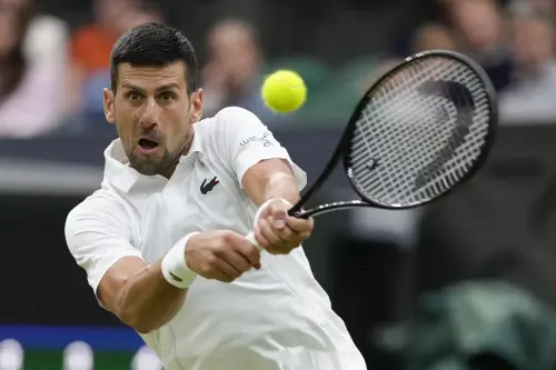 Novak Djokovic of Serbia plays a backhand return to Alexei Popyrin of Australia during their third round match at the Wimbledon tennis championships in London | Photo: AP/PTI