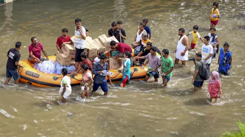 SDRF personnel distribute relief material to flood-affected people, in Guwahati | Photo: PTI