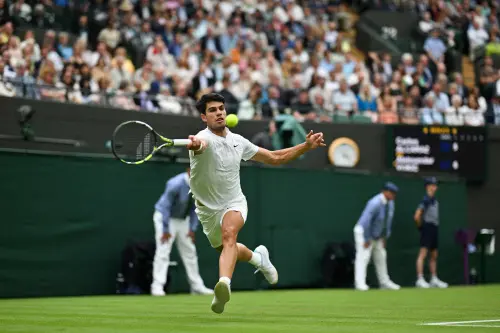 Spain's Carlos Alcaraz returns against Australia's Aleksander Vukic during their men's singles second round tennis match on the third day of the 2024 Wimbledon Championships at The All England Lawn Tennis and Croquet Club in Wimbledon | Photo: AFP