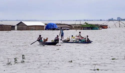 Villagers use a boat to cross a flood affected area