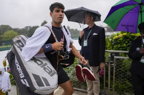 Spain's Carlos Alcaraz walks from the courts during a practice session ahead of the first round match of the Wimbledon tennis championships in London | Photo: AFP