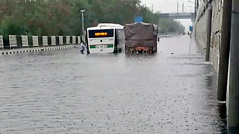 New Delhi: Vehicles partially submerged in the waterlogged Mandawali area following heavy rainfall, in New Delhi on Friday. (ANI Photo)