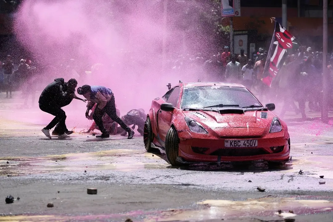 Protesters scatter as Kenya police sprays water cannon at them during a protest over proposed tax hikes in a finance bill in downtown Nairobi | Photo: AP/PTI