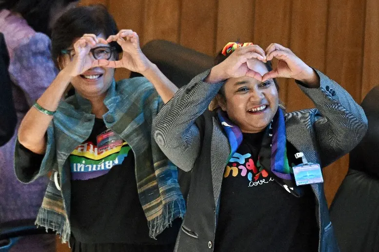 LGBTQ activists celebrate after the passing of the final senatorial vote on the same sex marriage bill at the Thai Parliament in Bangkok | Photo: AFP
