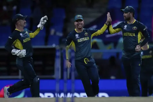 Australia's Glenn Maxwell, right, celebrates with teammates David Warner and wicket keeper Matthew Wade after taking the catch to dismiss Namibia's Michael Van Lingen for 10 runs during an ICC Men's T20 World Cup cricket match at Sir Vivian Richards Stadium in North Sound, Antigua and Barbuda. l Photo: AP/PTI