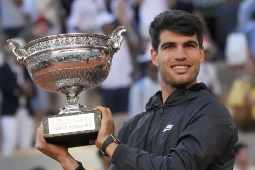 Spain's Carlos Alcaraz holds the trophy after winning the men's final of the French Open tennis tournament against Germany's Alexander Zverev at the Roland Garros stadium in Paris | Photo: AP