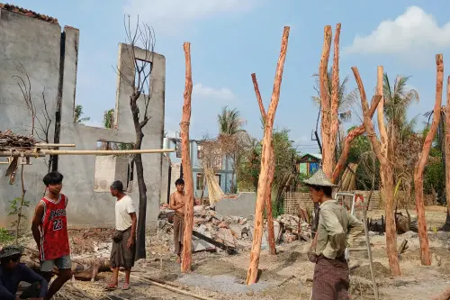 This photo shows people rebuilding temporary homes near a destroyed building following fighting between Myanmar's military and the Arakan Army (AA) ethnic minority armed group in a village in Minbya Township in western Rakhine State. l Photo: AFP