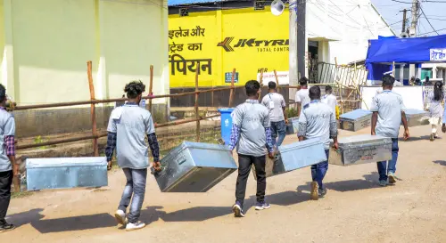 Polling officials carry ballots boxes to a counting centre | Photo: PTI