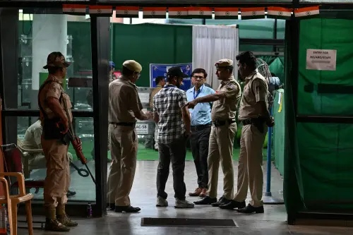 Security personnel inspect a man entering an election vote counting station in New Delhi. l Photo: AFP