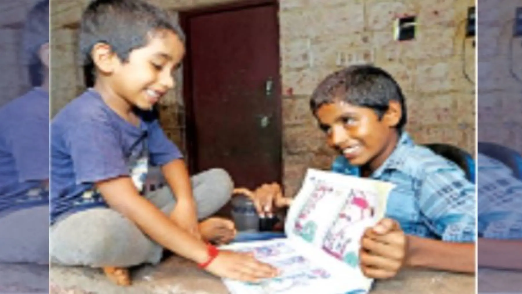 Ashiq checking the story written by his big brother Adidev in his text book | Photo: Mathrubhumi