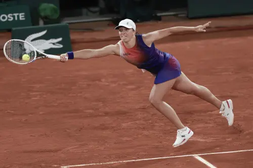 Poland's Iga Swiatek plays a shot against Japan's Naomi Osaka during their second round match of the French Open tennis tournament at the Roland Garros stadium in Paris. l Photo: AP
