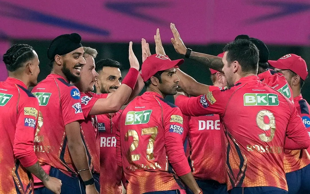 Punjab Kings' captain Sam Curran celebrates with teammates after taking the wicket of Rajasthan Royals' Yashasvi Jaiswal | Photo: PTI