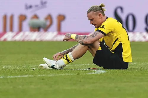 Dortmund's Marius Wolf sits on the pitch after the German Bundesliga soccer match between FSV Mainz 05 and Borussia Dortmund in Mainz, Germany. l Photo: AP