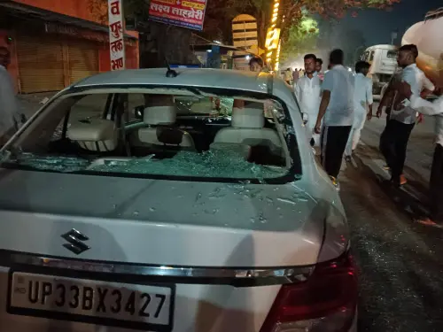 People stand near a vehicle that was allegedly vandalised by some unidentified men outside the Congress office at Gauriganj in Amethi. l Photo: PTI