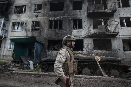 Ukrainian soldier passes by a damaged apartment building in Chasiv Yar, the site of heavy battles with the Russian forces in the Donetsk region. I File Photo: AP