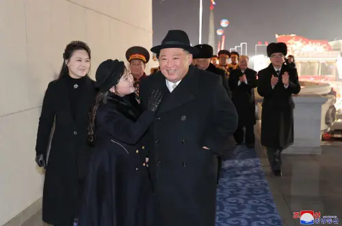 This picture taken on February 8, 2023 and released from North Korea's official Korean Central News Agency (KCNA) on February 9, 2023 shows North Korea's leader Kim Jong Un (R), his daughter presumed to be named Ju Ae (C) and wife Ri Sol Ju (L) attending a military parade celebrating the 75th anniversary of the founding of the Korean People's Army in Kim Il Sung Square in Pyongyang | Photo: AFP