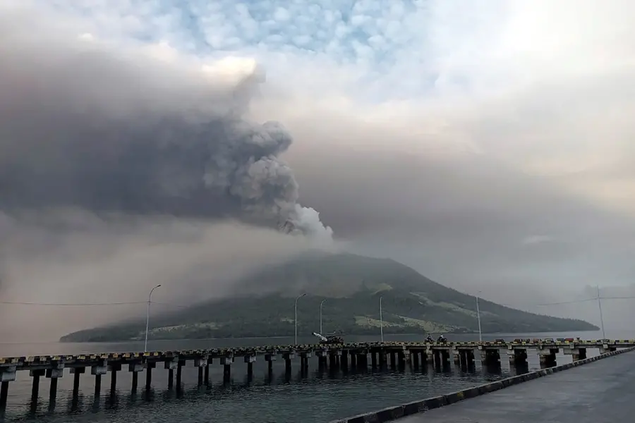 Indonesians leave homes near erupting volcano and airport closes due to ash danger