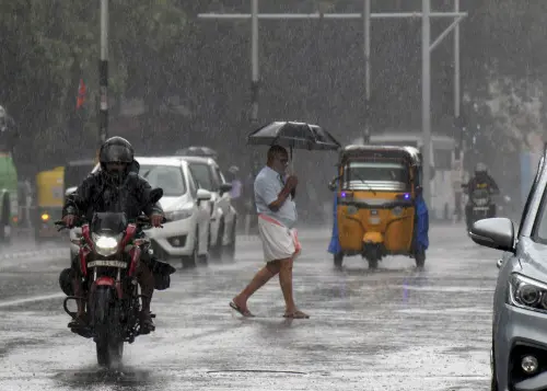 Commuters on a road amid rainfall, in Thiruvananthapuram | Photo: PTI