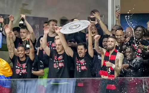 Leverkusen players celebrate with a makeshift trophy after Bayer Leverkusen won the German Bundesliga title beating Werder Bremen in Leverkusen, Germany, on Sunday. l Photo: AP