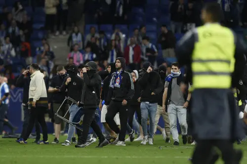 Espanyol fans react to Barcelona's victory invading the pitch | AFP
