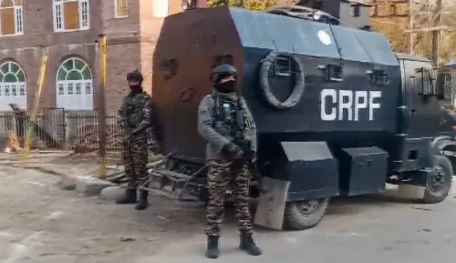 Security personnel stand guard after an encounter broke out between security forces and terrorists, in Pulwama district on Thursday. l Photo: PTI
