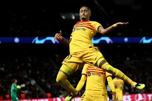 Barcelona's Brazilian forward #11 Raphinha leaps in the air as he celebrates scoring Barcelona's second goal during the UEFA Champions League quarter final first leg football match between Paris Saint-Germain (PSG) and FC Barcelona at the Parc des Princes stadium in Paris. l Photo: AFP