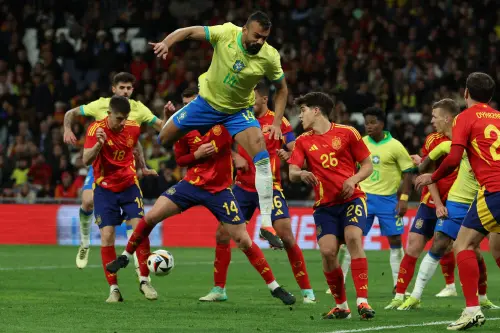 Brazil's defender #14 Fabricio Bruno jumps for the ball next to Spain's defender #26 Pau Cubarsi during the international friendly football match between Spain and Brazil at the Santiago Bernabeu stadium in Madrid. l Photo: AFP