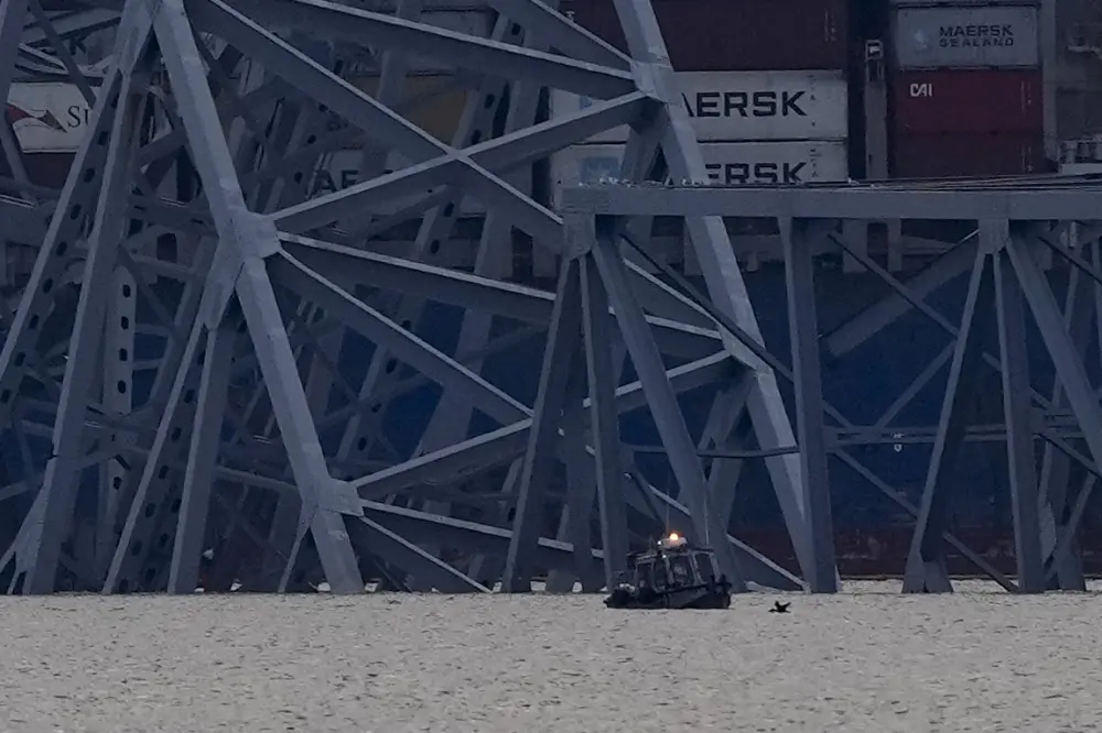 A container ship rests against wreckage of the Francis Scott Key Bridge | AP