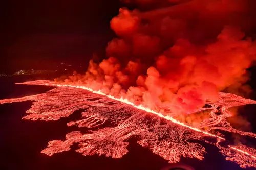 This handout picture released by the Icelandic Coast Guard on March 16, 2024 shows billowing smoke and flowing lava pouring out of a new fissure, during a surveilance flight above a new volcanic eruption on the outskirts of the evacuated town of Grindavik, western Iceland. (Photo: AFP)